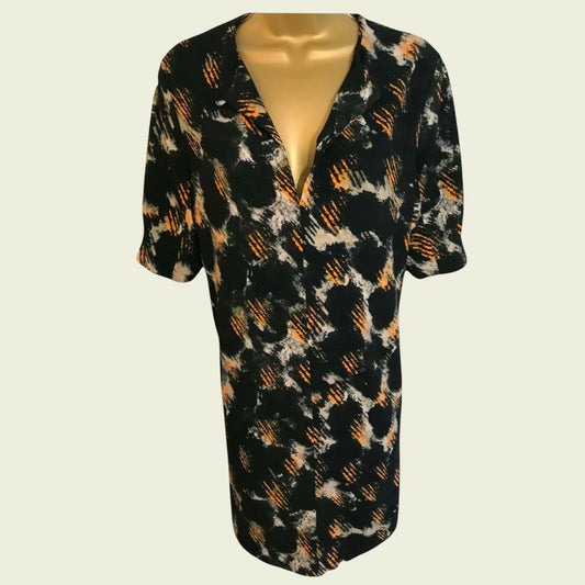 Black patterned dress on a mannequin against a white background