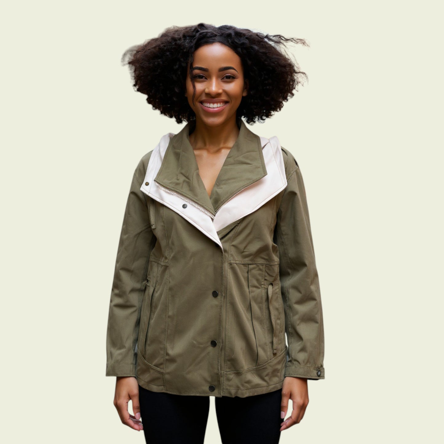 Model wearing khaki rain coat on beige background