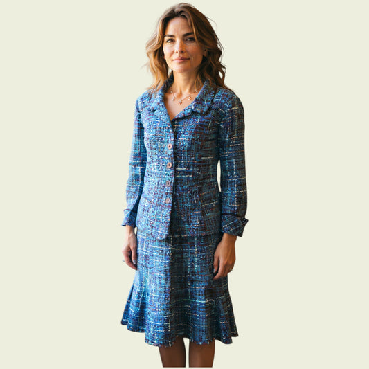 Model wearing blue boucle jacket and skirt on beige background