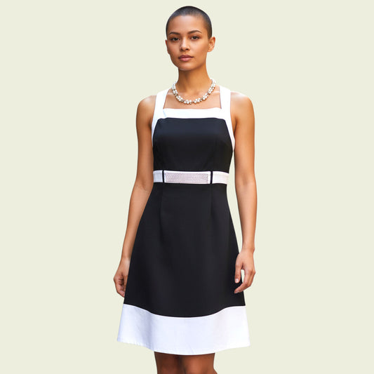 Model wearing black and white dress with diamante detail