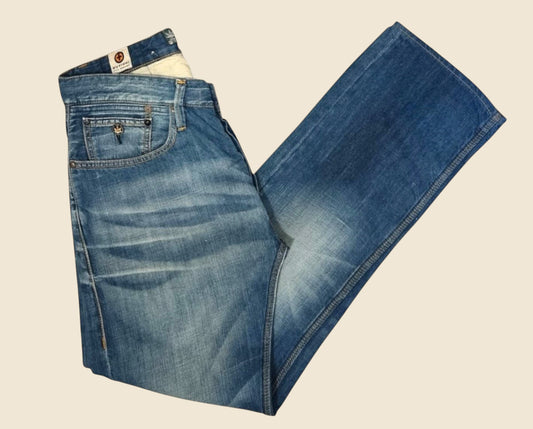 Pair of blue jeans on a beige background