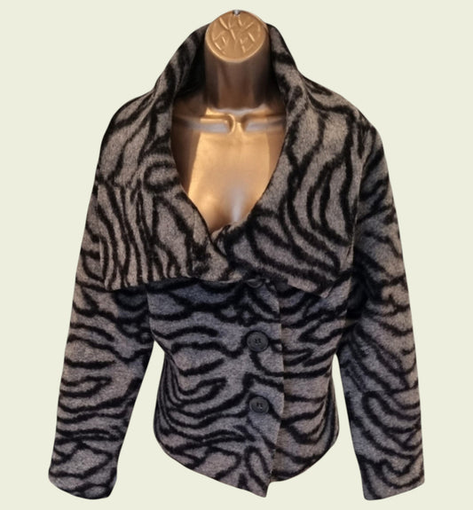 Zebra-patterned jacket on a mannequin against a beige background