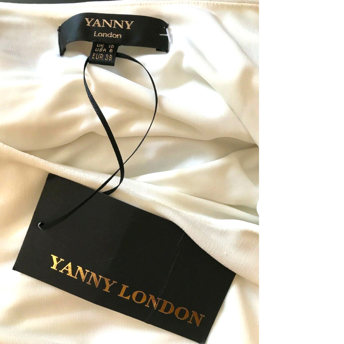 Yanny London tag on a white fabric background