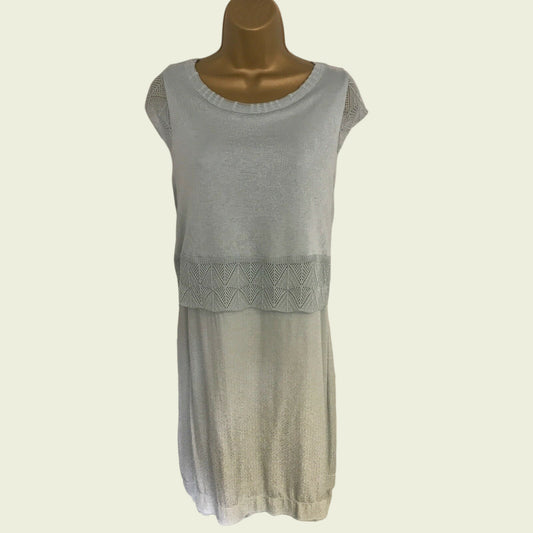 Light green sleeveless dress on a mannequin against a plain background