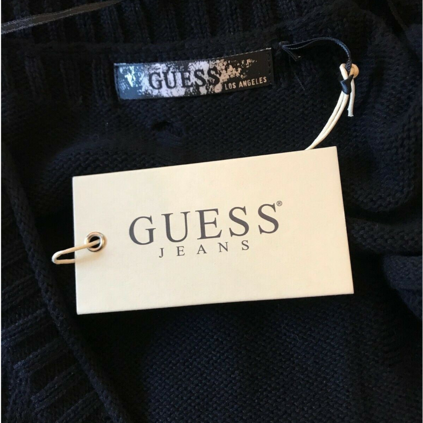 Guess jeans label on a dark fabric background