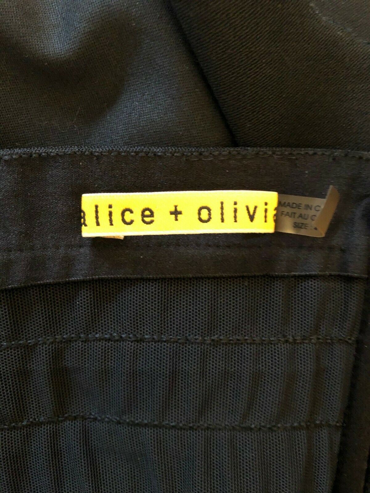 Label with 'alice + olivia' on a dark fabric background