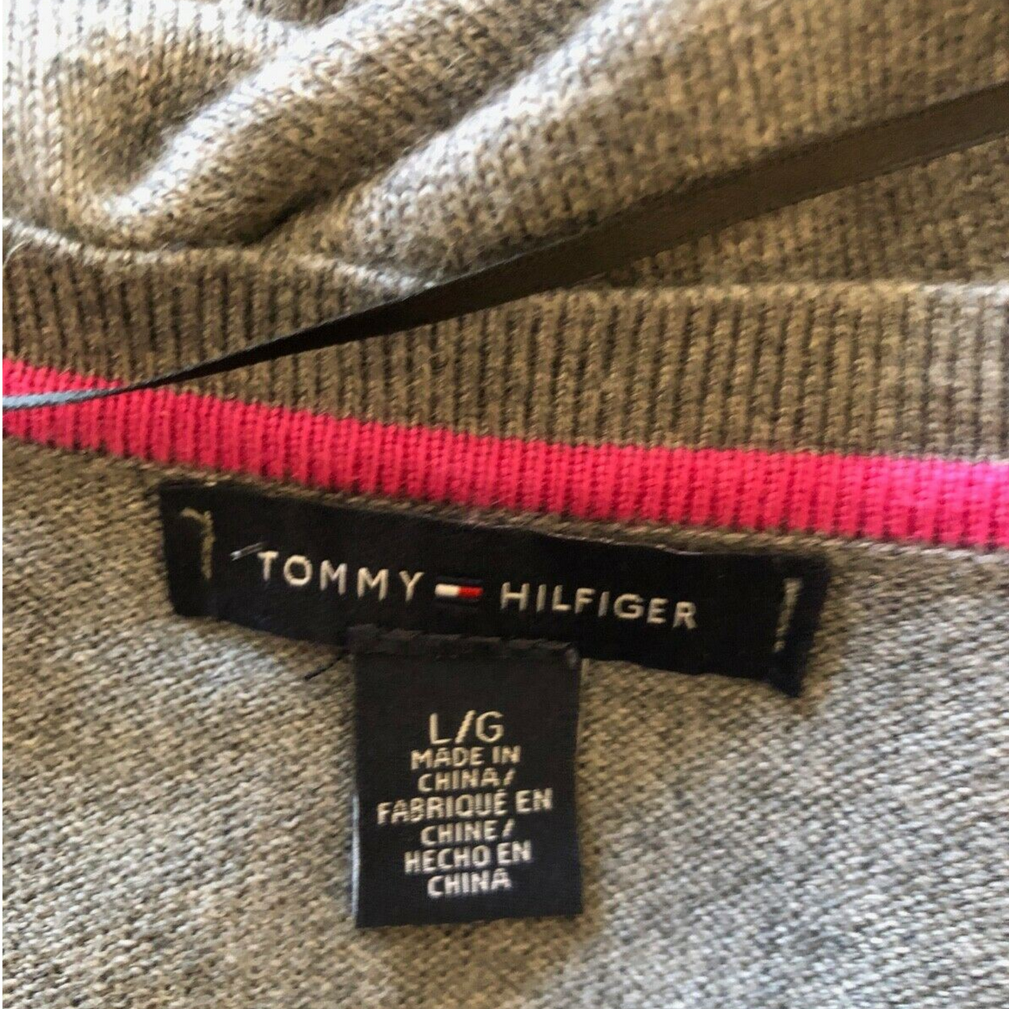 Tommy Hilfiger label on a garment with a pink zipper