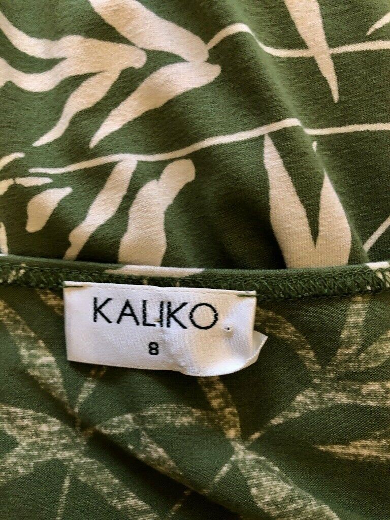 Green fabric with beige leaf pattern and a 'KALIKO' label