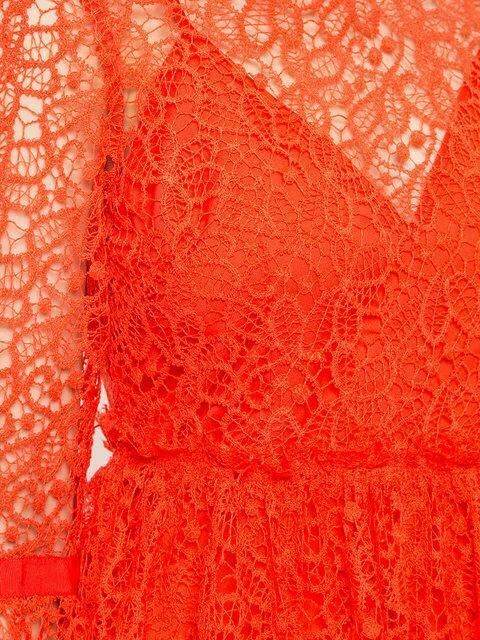 Close-up of red lace fabric with intricate patterns