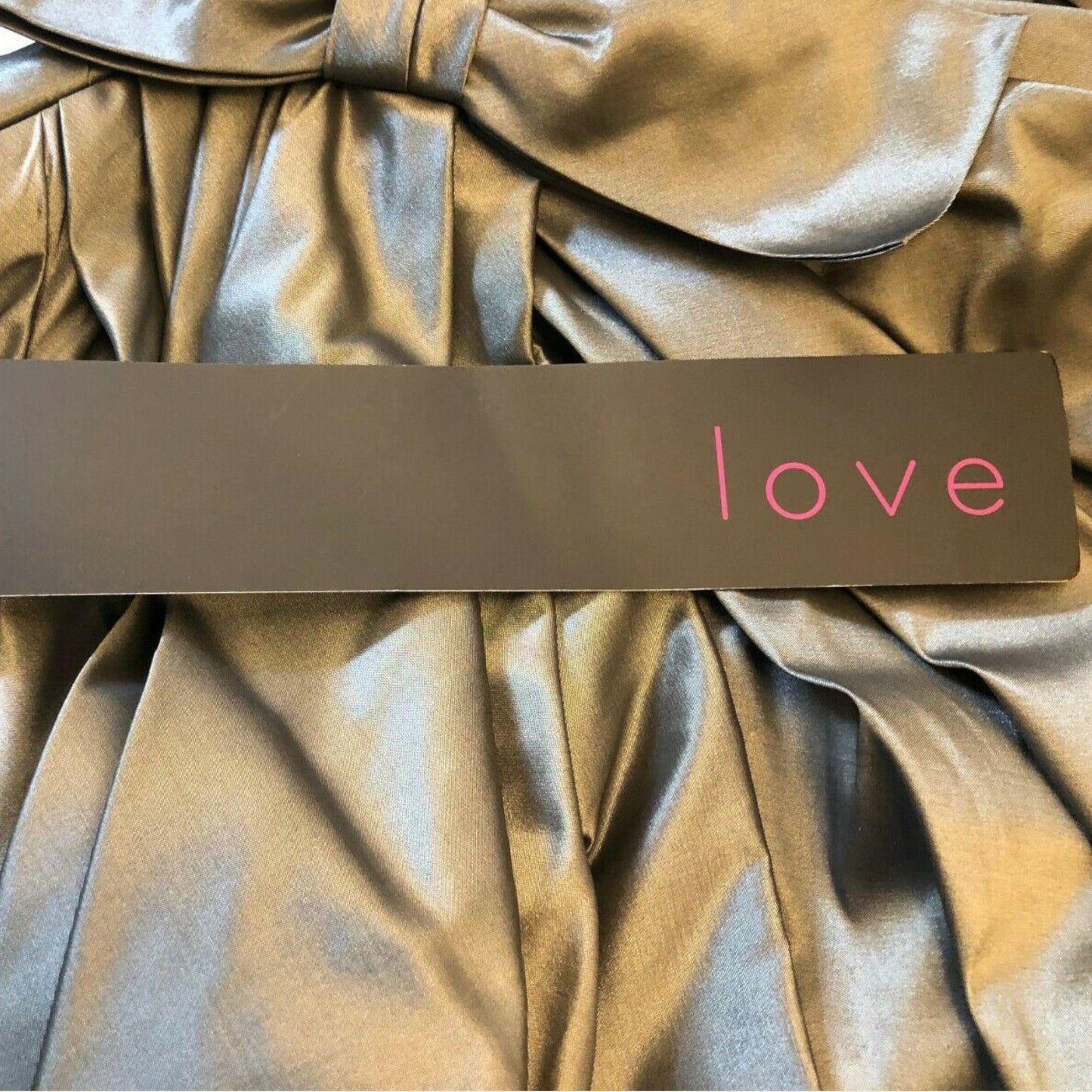 Grey fabric with a brown strip featuring the word 'love' in pink.