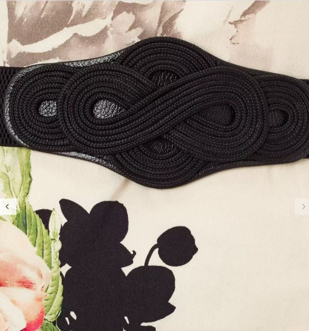 Black woven belt on a floral and abstract background