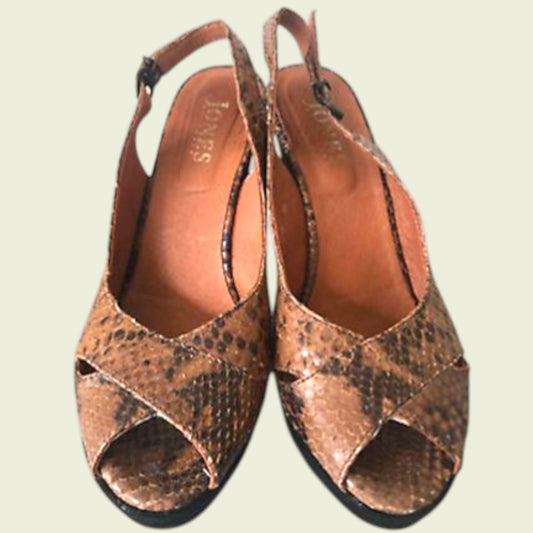 Pair of brown open-toe sandals with snake print on a light background