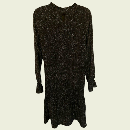 Black and white polka dot pleated dress on beige background