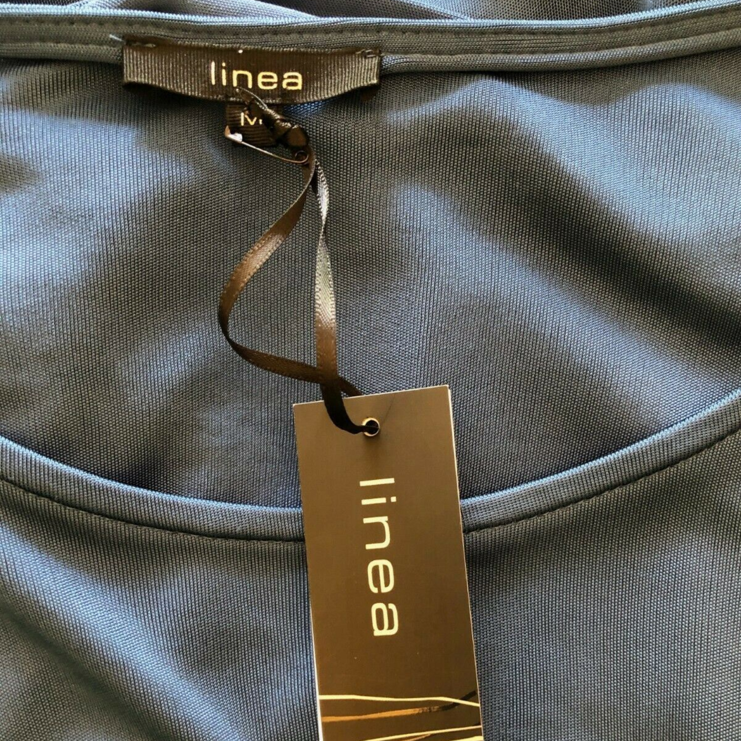 Linea label on blue fabric