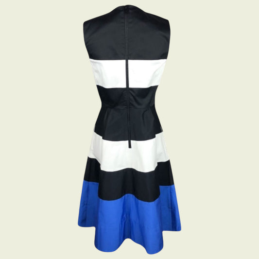 Black, white, and blue dress on a beige background