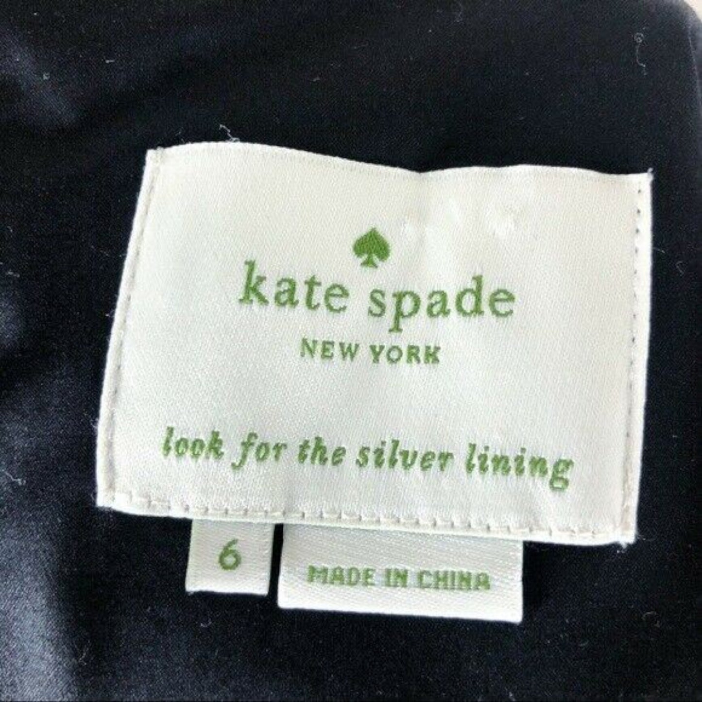 Kate Spade New York label on a garment with 'look for the silver lining' text.