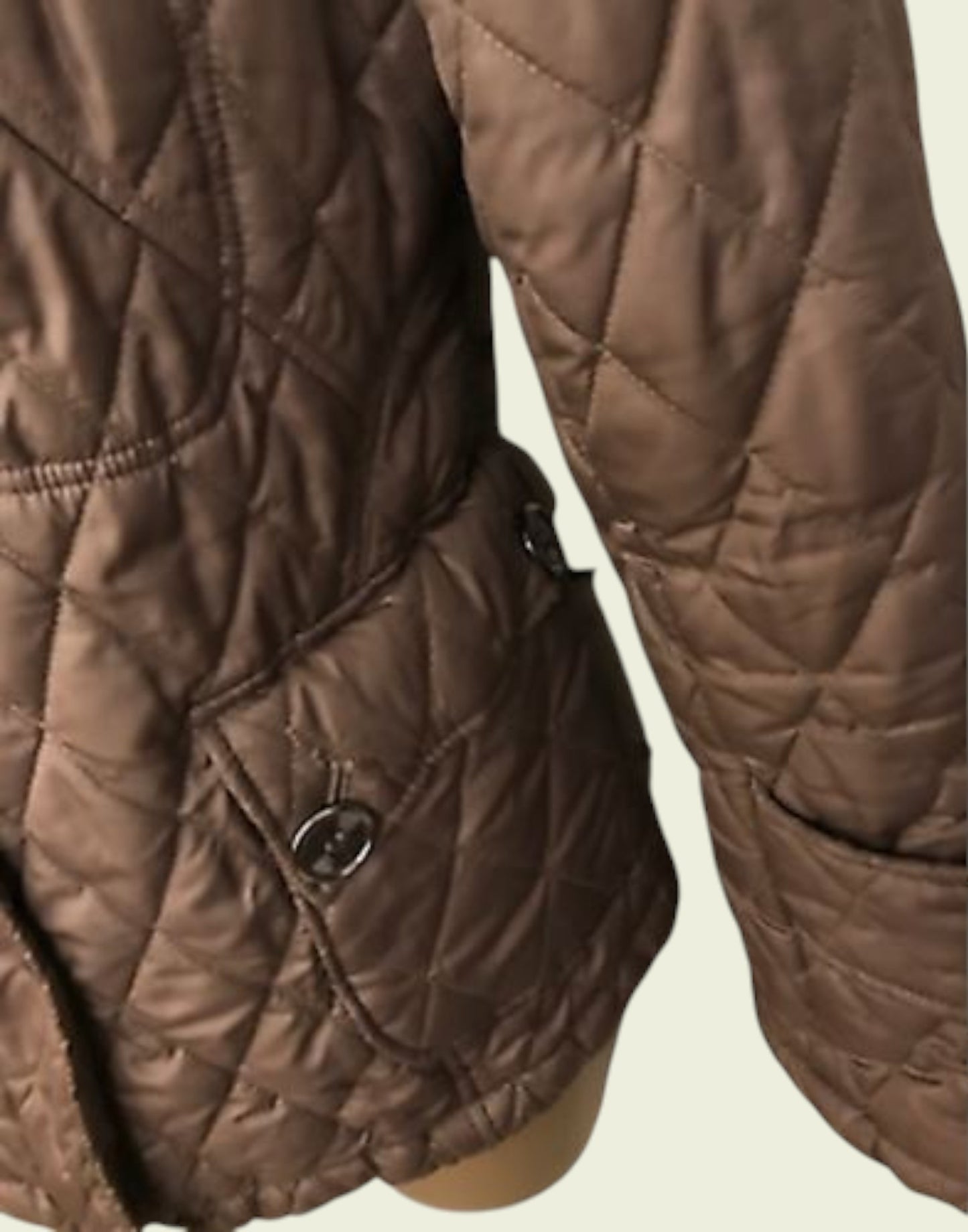 Brown quilted jacket on a beige background