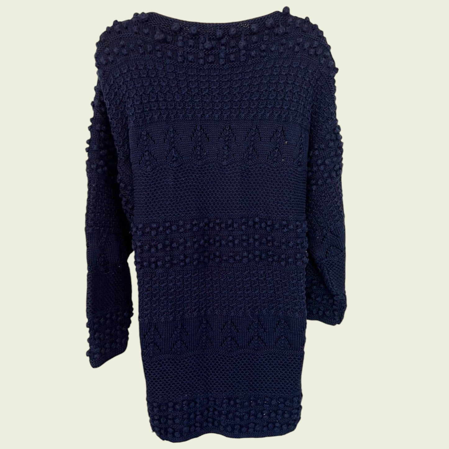 Navy blue knitted jumper on a beige background