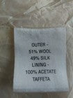 Textile label with fabric composition details on a white background