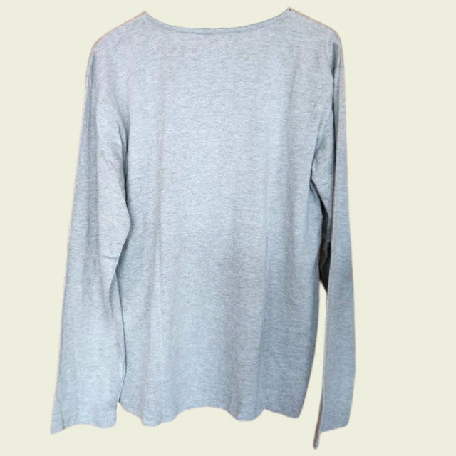 Grey long-sleeve shirt on a beige background