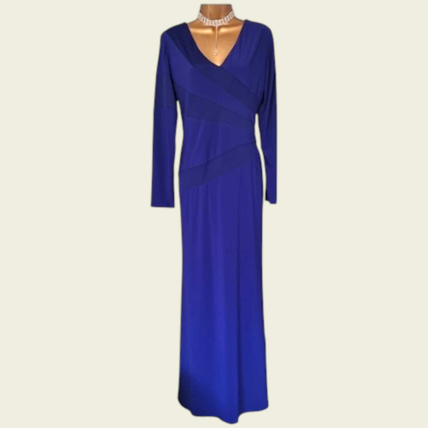 Blue evening gown on a mannequin with a plain background