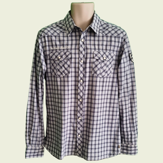 Plaid shirt on a mannequin against a beige background