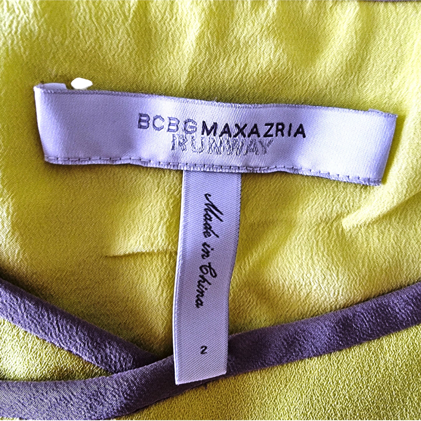 Label with 'BOBG Maxazria' on a yellow fabric background