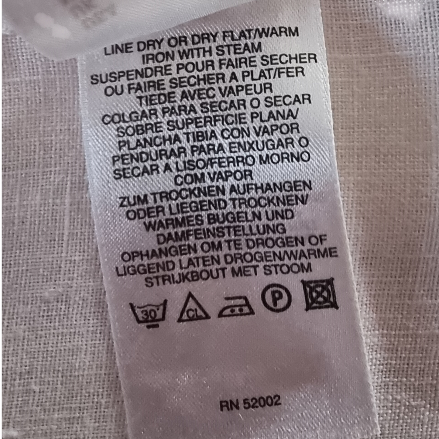 Washing instructions label on a fabric background