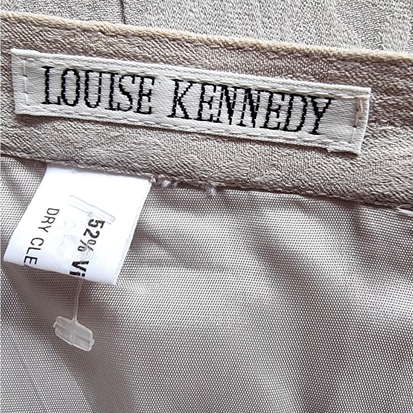 Label with 'Louise Kennedy' on a fabric background