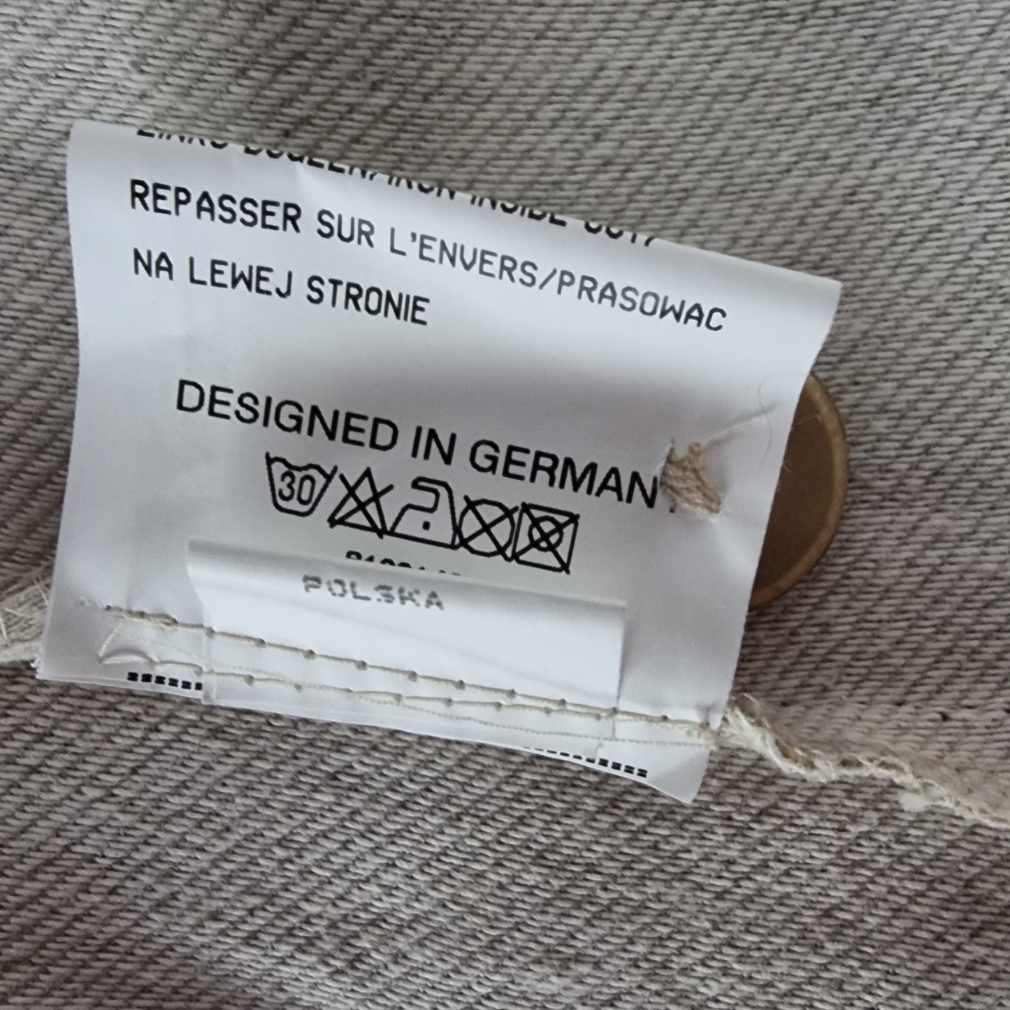 Clothing label with text on a fabric background