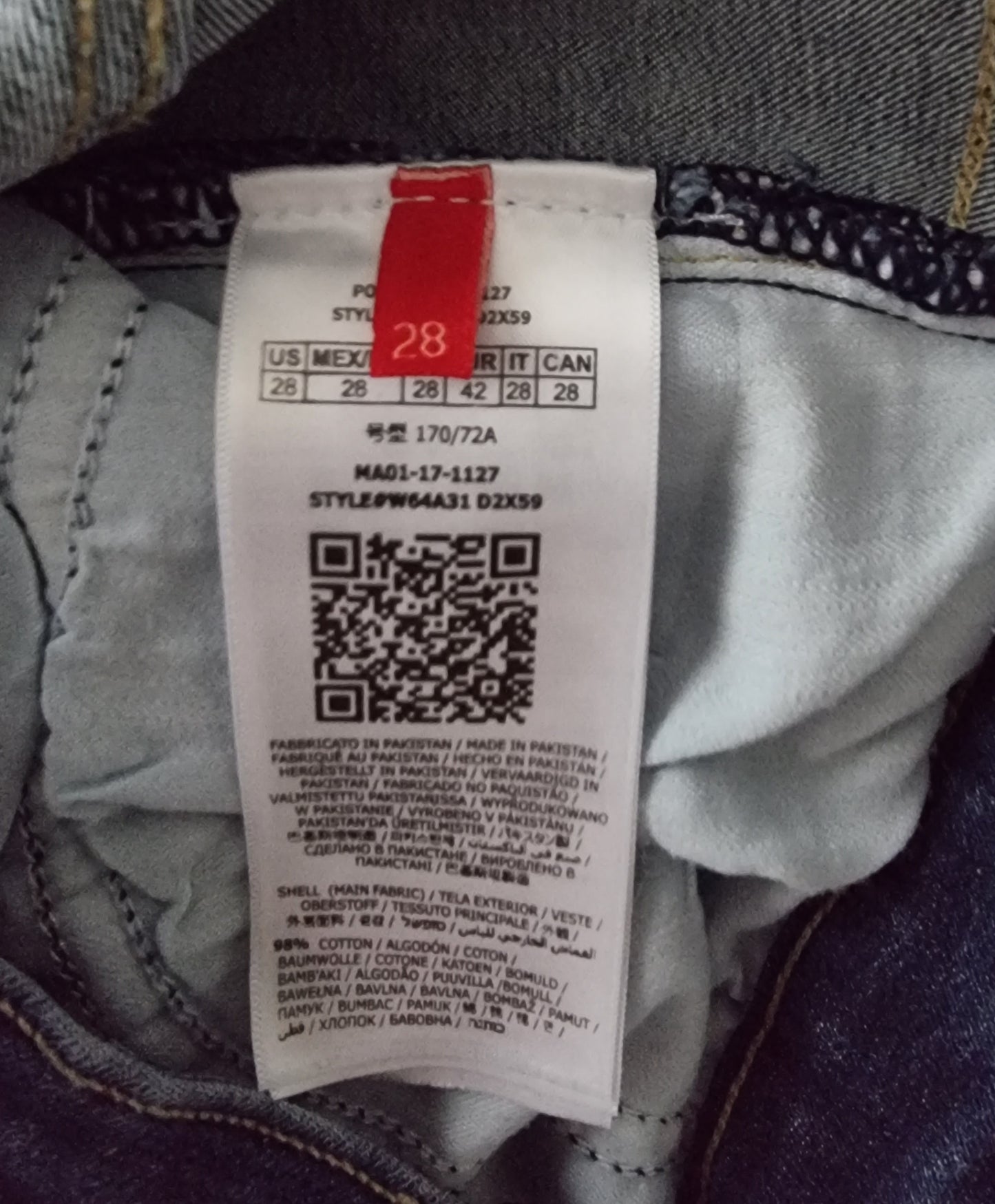 Clothing tag with size label and QR code on a garment