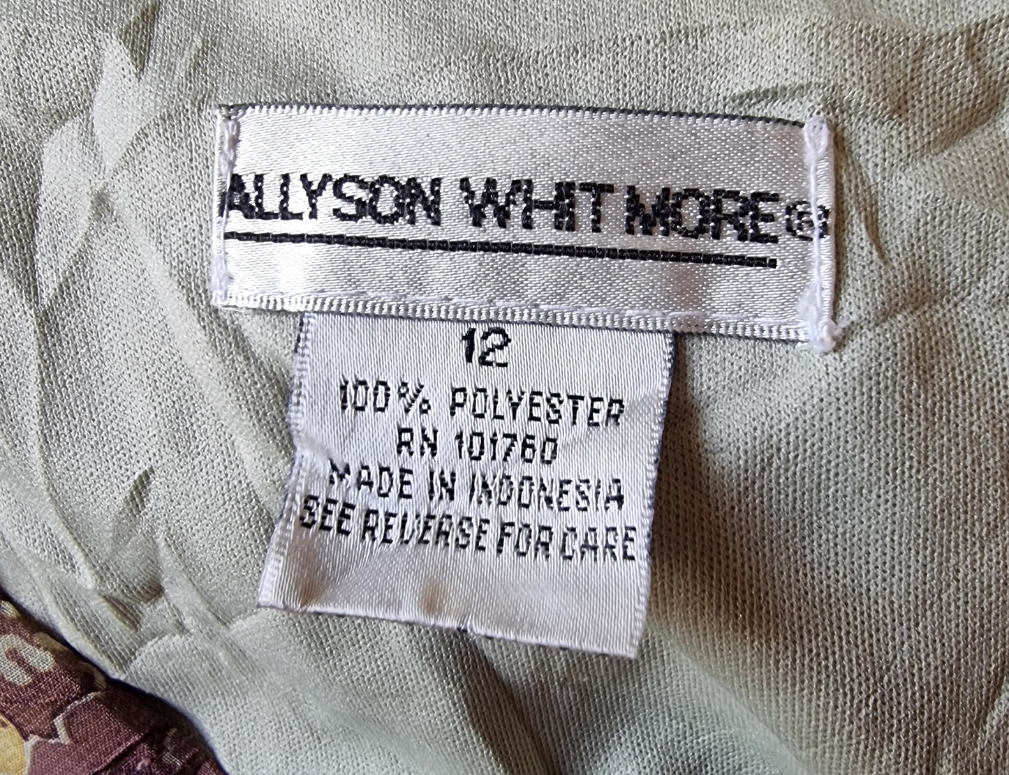 Fabric label with 'Allyson Whitmore' branding on a textured fabric background