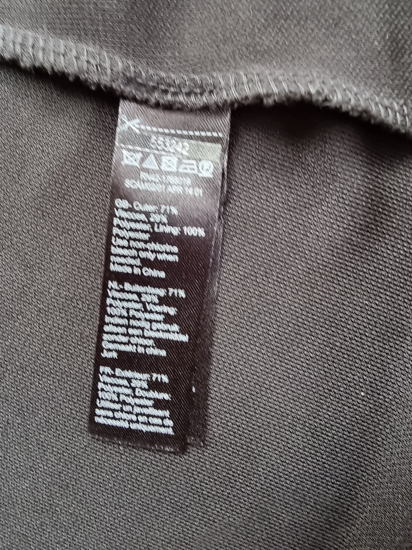 Clothing tag on a black fabric background