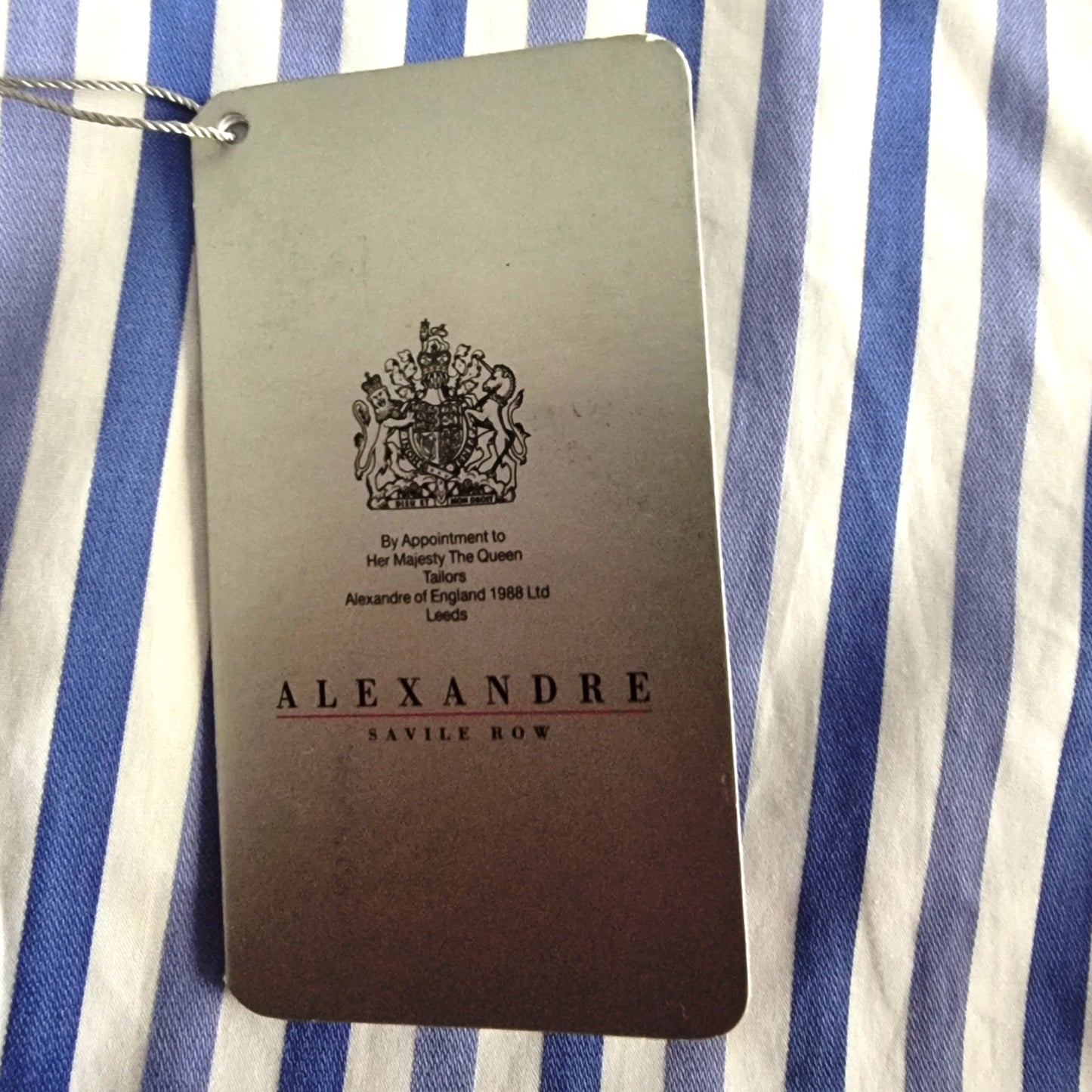 Alexandre Savile Row label on a blue and white striped fabric background