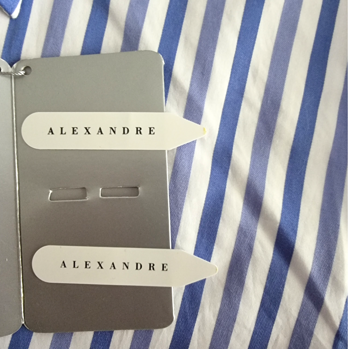 Two 'ALEXANDRE' branded items on a blue and white striped background