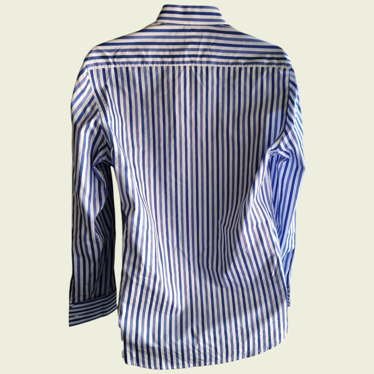 Blue and white striped shirt on a beige background