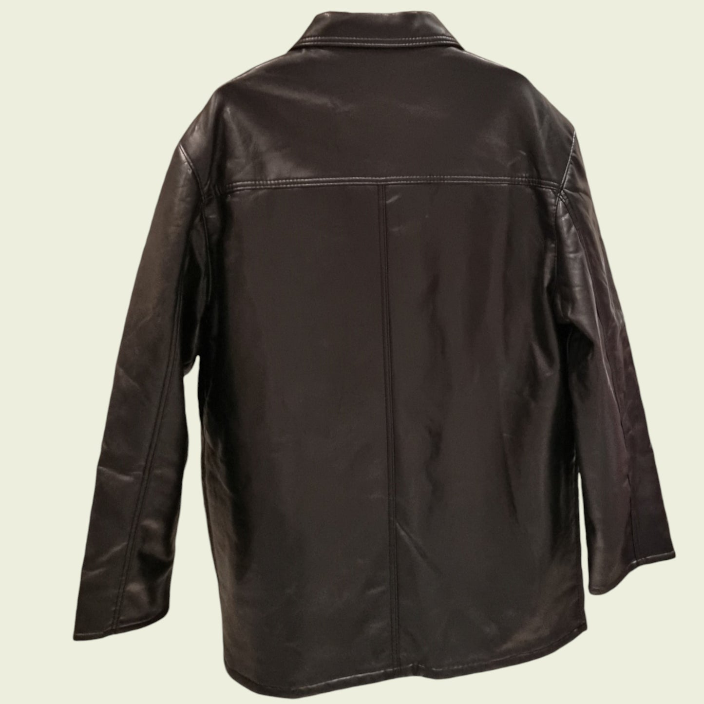 Black leather jacket on a beige background