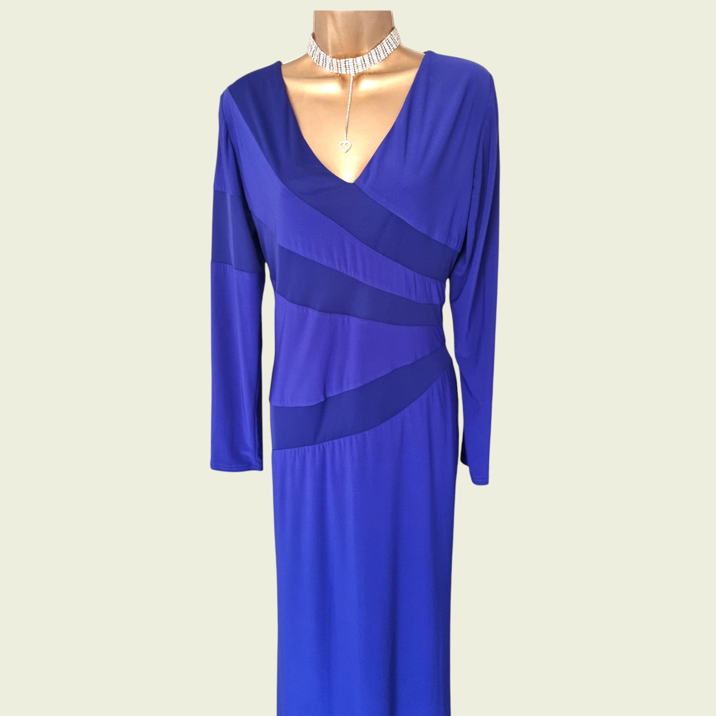 Blue dress on a mannequin against a beige background