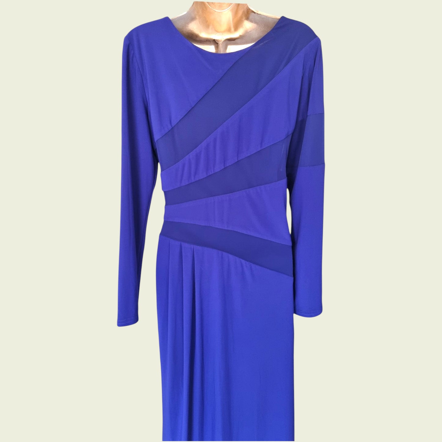 Blue dress with long sleeves on a beige background