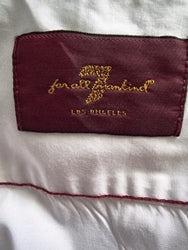 Close-up of a label on a garment with text and branding details.