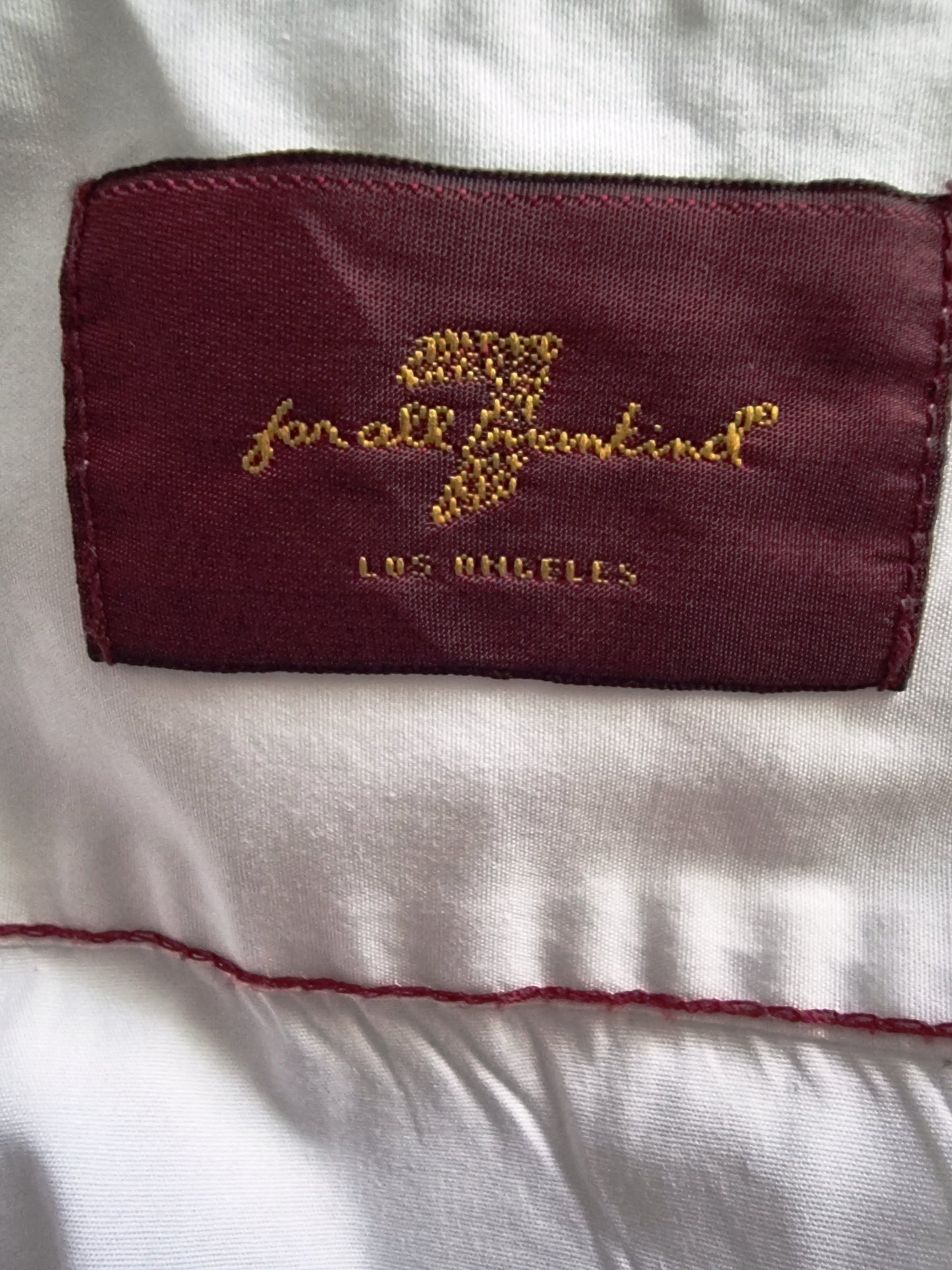 Embroidered label on a white garment with 'Los Angeles' text