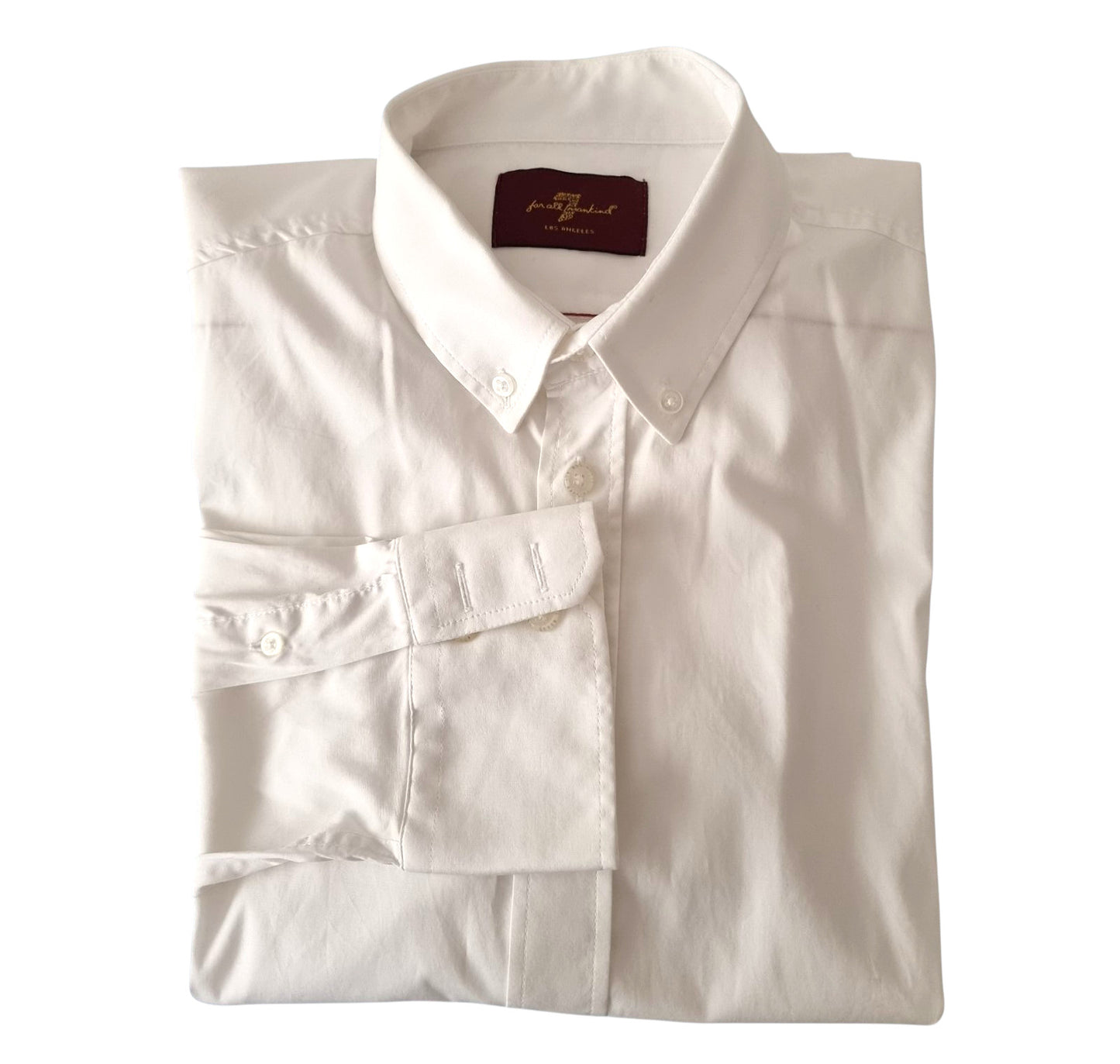 Folded white dress shirt with a collar tag on a white background