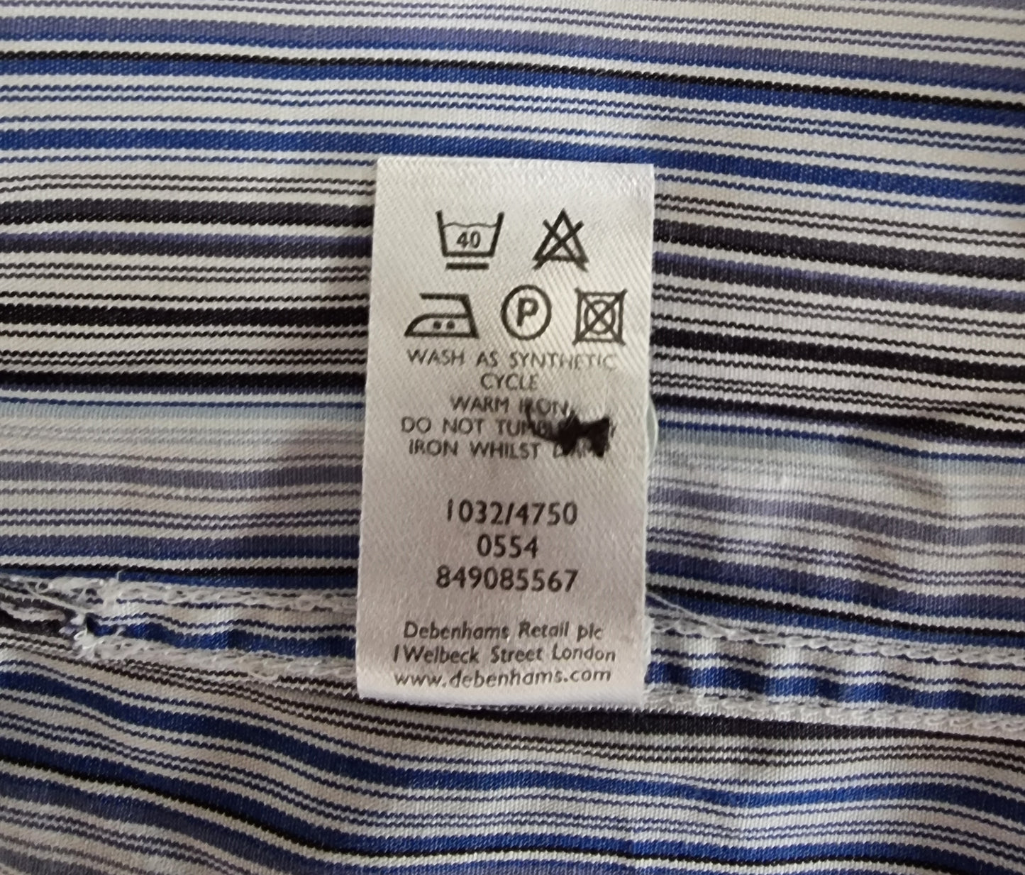 Clothing label on a striped fabric background