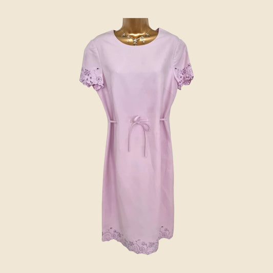 Light purple dress with lace details on a beige background