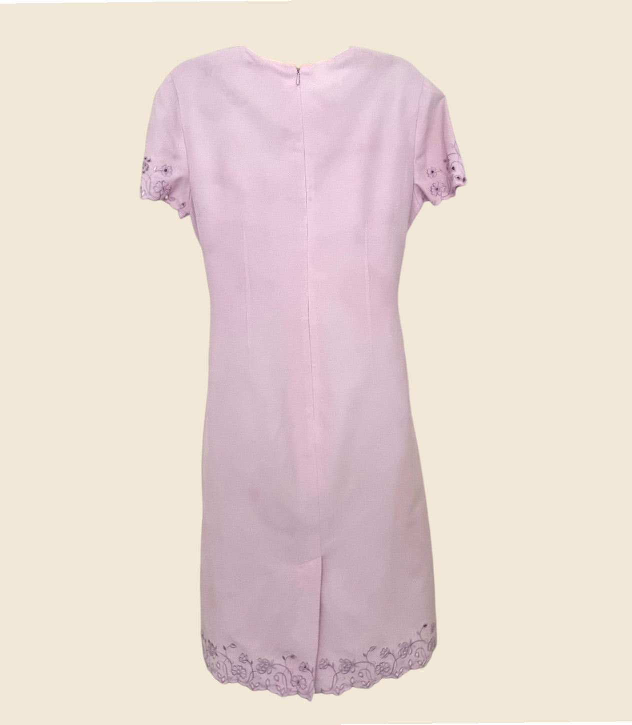 Light purple dress with lace details on a beige background