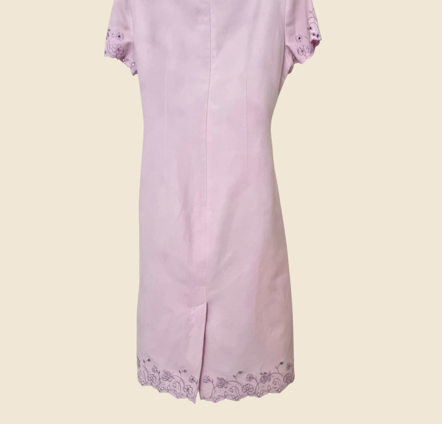 Light purple dress with lace details on a light beige background