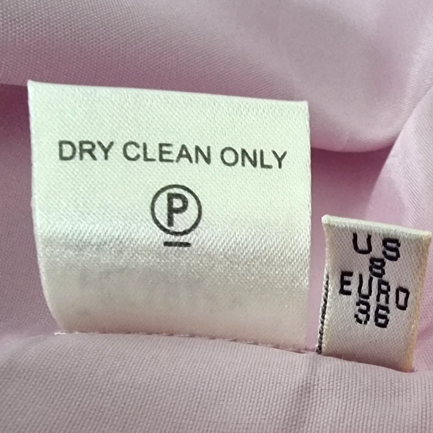 Garment label detailing care instructions on white background