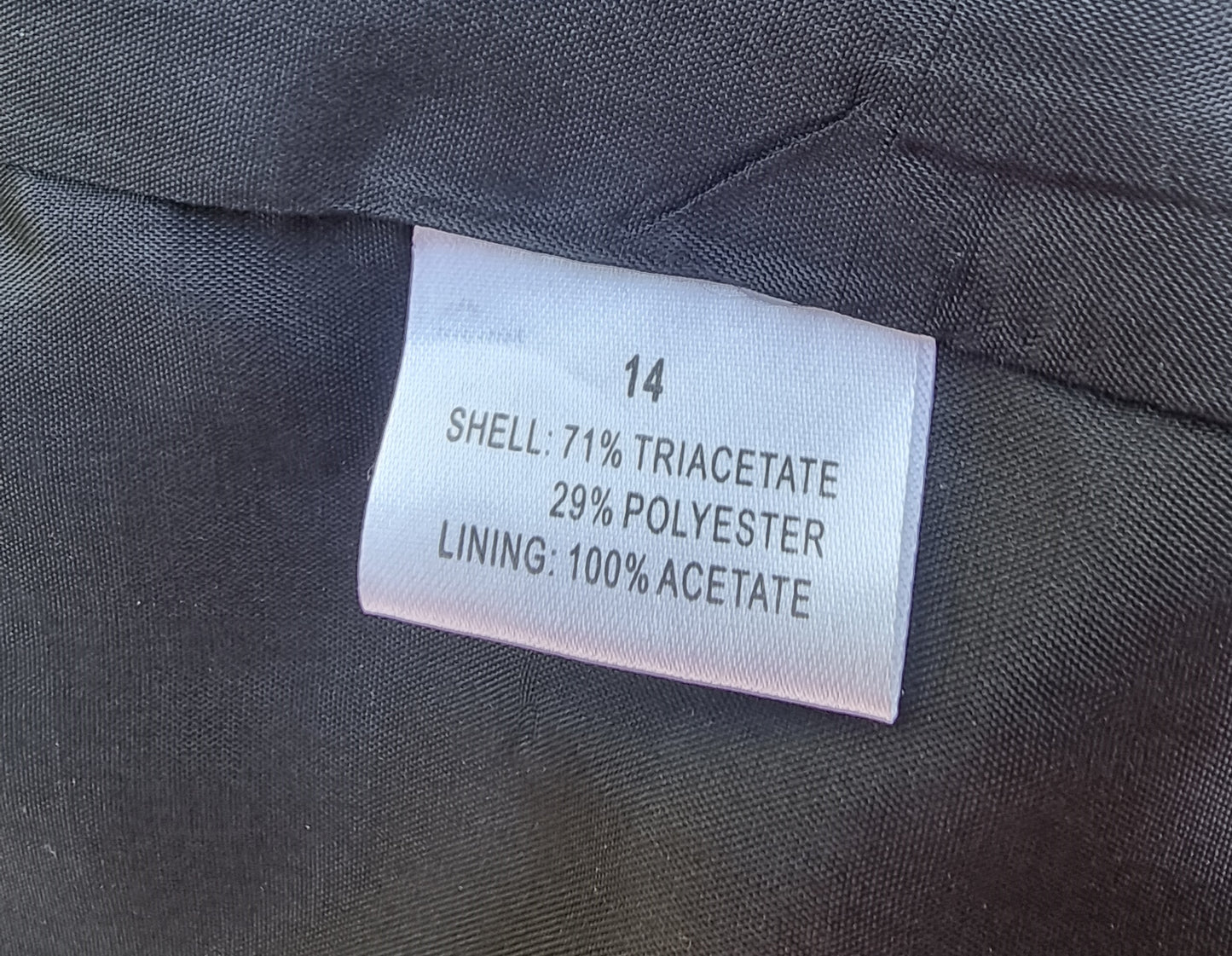 Fabric composition label on a gray fabric background