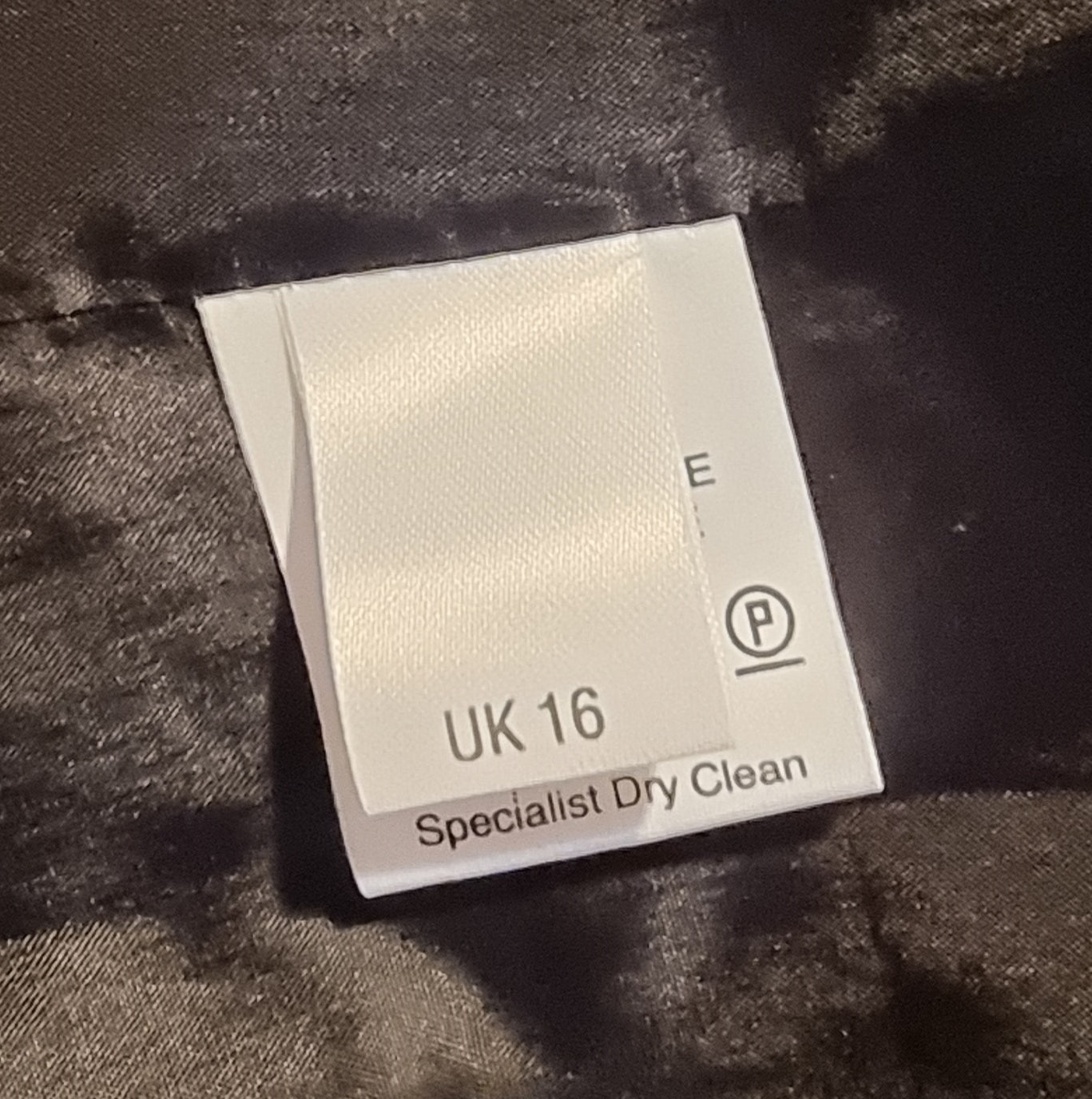 Fabric care label on a textured surface