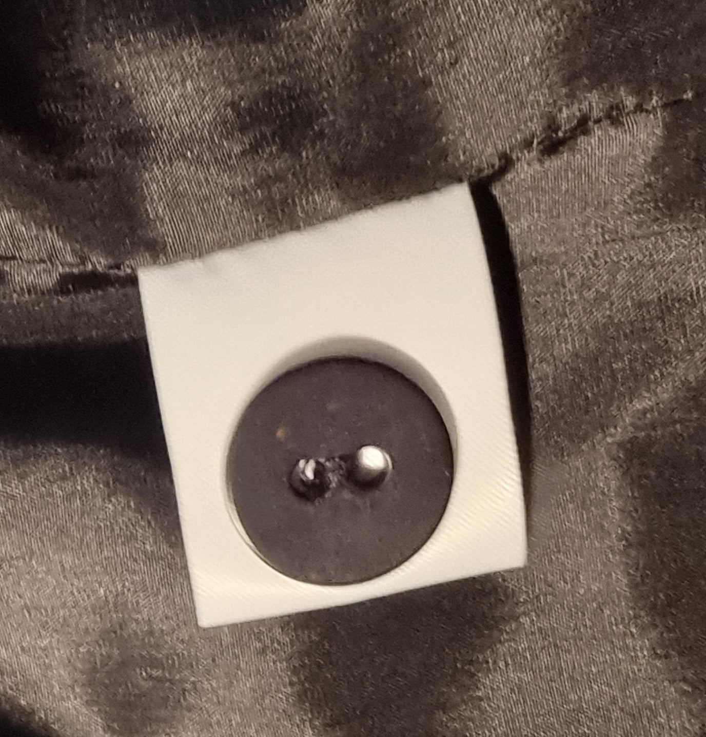 Button on a piece of fabric